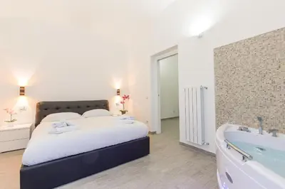 a bedroom with a bed and a bath tub at Suite House Vaticano in Rome