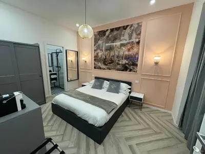 a bedroom with a bed and a painting on the wall at Domus Avi Vaticano in Rome