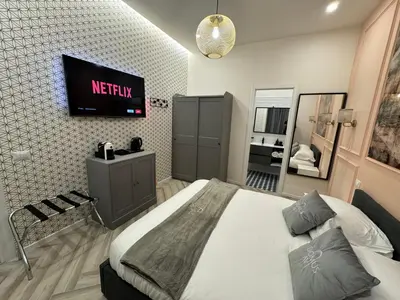 a bedroom with a bed and a tv on the wall at Domus Avi Vaticano in Rome