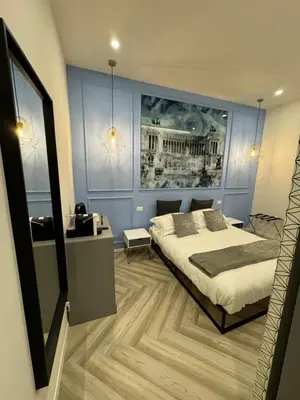 a bedroom with a bed and a painting on the wall at Domus Avi Vaticano in Rome