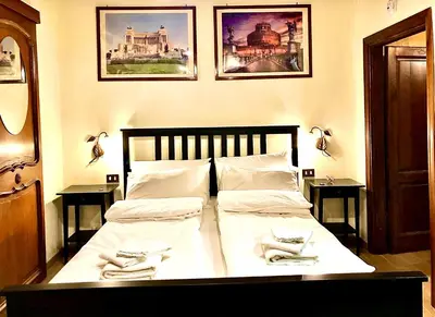a bedroom with a bed with white sheets and napkins on it at La Tana al Flaminio in Rome
