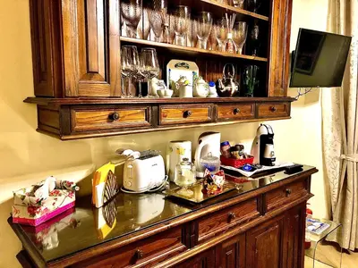 a kitchen counter with glasses on a shelf at La Tana al Flaminio in Rome