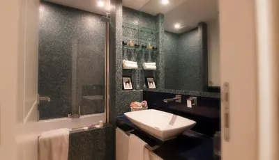 a bathroom with a sink and a mirror at Urbanflat Roma in Rome