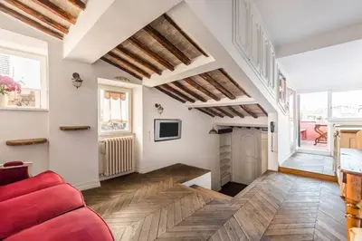 a living room with a red couch and a fireplace at Scala Lovely Terrace Apartment in Rome