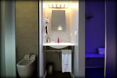 a bathroom with a sink and a toilet and a tub at Wrooms Guest House in Rome