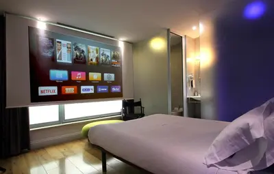 a bedroom with a bed and a flat screen tv at Wrooms Guest House in Rome