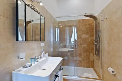 a bathroom with a sink and a shower at Vatican Domus Luxury Rooms in Rome