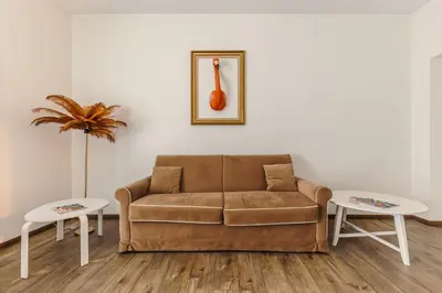 a living room with a couch and two tables at T-House Fontana di Trevi in Rome