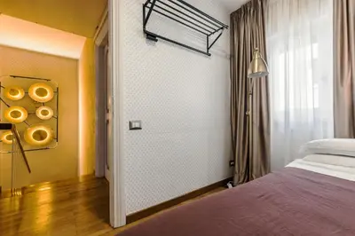 a bedroom with a bed and a window at T-House Fontana di Trevi in Rome