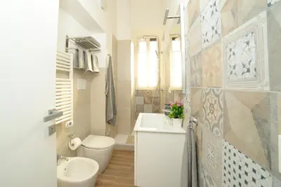 a bathroom with a toilet and a sink and a toilet at La dolce casa di Giulia in Rome