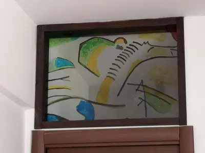 a stained glass window of a bird on a branch at Checchi House in Rome