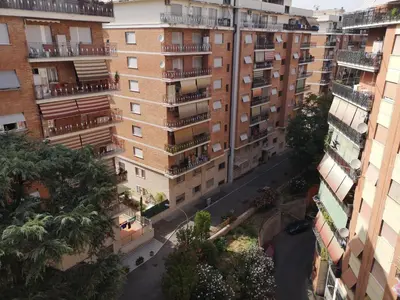 an overhead view of a city street with tall buildings at Checchi House in Rome