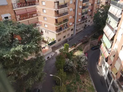 an overhead view of a city street with buildings at Checchi House in Rome