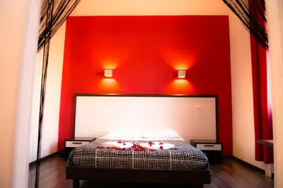 a red bedroom with a bed with red walls at Chroma Exy - Chroma Italy in Rome