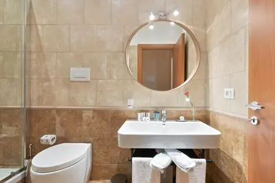 a bathroom with a sink and a toilet and a mirror at Vatican Domus Smart Rooms in Rome