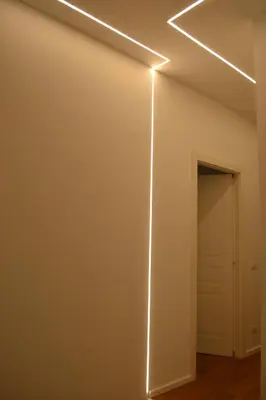 a room with a wall with a light on it at 500 Suite Prati delle Vittorie in Rome