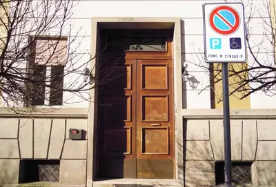 a door to a building with a no parking sign in front at 500 Suite Prati delle Vittorie in Rome