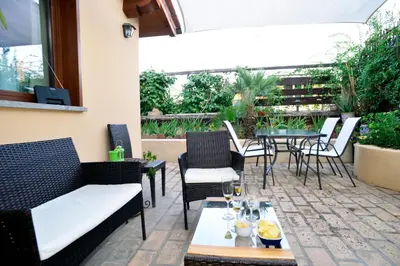 a patio with chairs and a table with wine glasses at St. Petrus et Aurelia in Rome