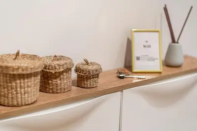 a shelf with three baskets on top of a counter at La casa di Effe in Rome
