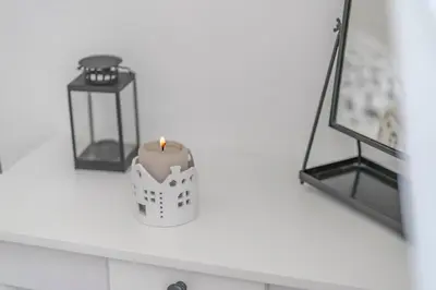 a candle on a counter next to a candle holder at La casa di Effe in Rome