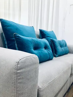 a couch with blue pillows on top of it at Mamma Roma 151 in Rome