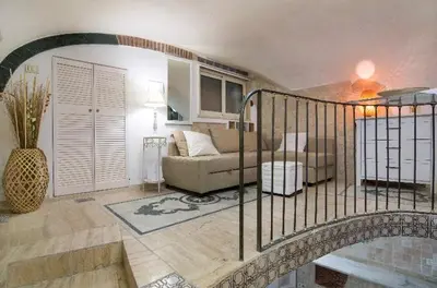 a living room with a staircase leading to a living room at Ancient Roman Mansion in Rome