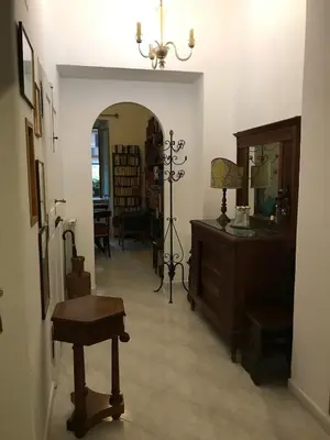 a hallway filled with furniture and a table and a lamp at Casa Vacanze Casilina in Rome