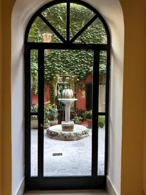 a view of a fountain through a window at La Calla al Colosseo in Rome