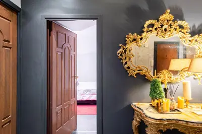 a mirror on a wall next to a table in a room at Rome in your heart - Spagna Single Room in Rome