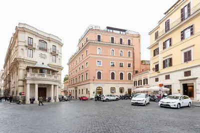 a city street with cars parked in front of buildings at Rome in your heart - Spagna Single Room in Rome
