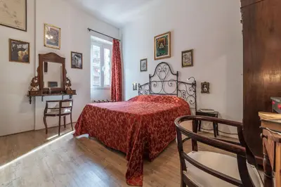 a bedroom with a bed with a red bedspread at San Paolo Steampunk Flat in Rome