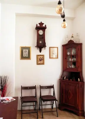 a room with two chairs and a clock on a wall at San Paolo Steampunk Flat in Rome