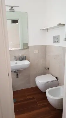 a bathroom with a sink and a toilet and a mirror at Vatican Home in Rome - Suite St. Peter's View in Rome