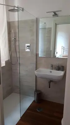 a bathroom with a sink and a glass shower at Vatican Home in Rome - Suite St. Peter's View in Rome