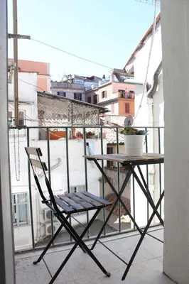 a chair sitting on a balcony with a table at Santa Maria Suites in Rome
