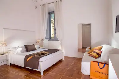 a bedroom with two beds and a couch in it at Domus Liberius - Rome in Rome