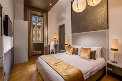 a bedroom with a large bed and a television at Domus Liberius - Rome in Rome