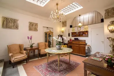 a living room with a vase of flowers on a table at Navona Gallery Suites in Rome