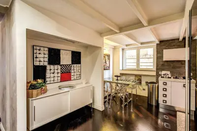 a kitchen with a counter and a table in it at Spacious Flat by Piazza Navona in Rome