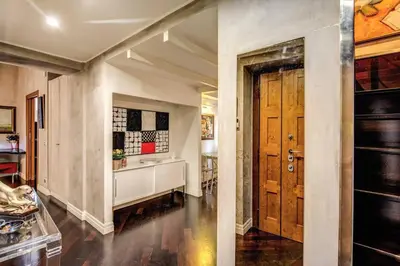 a hallway with a door and a kitchen at Spacious Flat by Piazza Navona in Rome