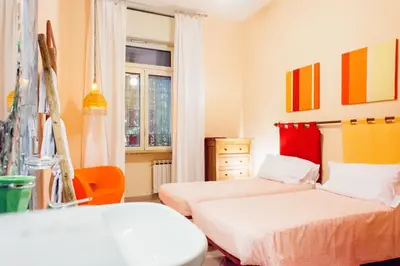 a bedroom with two beds and a window at The Beehive Hostel in Rome