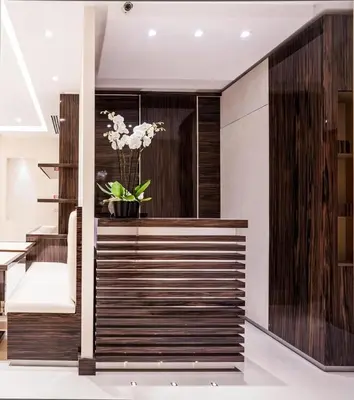 a lobby with a staircase with a vase of flowers at Maison Candia Luxury House in Rome