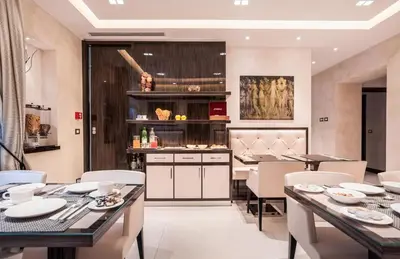 a dining room with tables and chairs and a counter at Maison Candia Luxury House in Rome