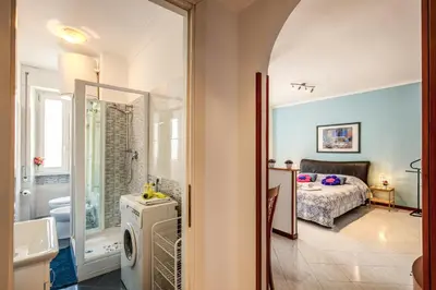 a bathroom with a sink and a bed in a room at Sunrise Apartment in Rome