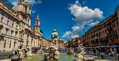 a fountain in the middle of a city with buildings at Orso Apartment in Rome