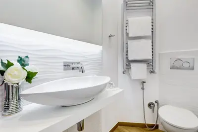 a white bathroom with a sink and a toilet at Opera Private Suites by Premium Suites Collection in Rome
