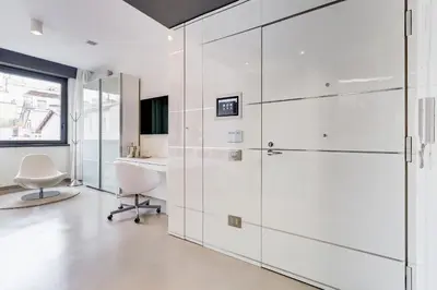 an office with white cabinets and a desk and a window at EMERALD Luxury Suite Apartment in Rome