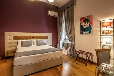 a bedroom with a large bed and a window at Hotel Paba in Rome