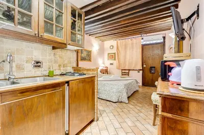 a kitchen with a sink and a bed in a room at Colosseum Rione Monti 1 in Rome