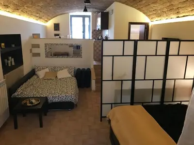 a bedroom with a bed and a table in a room at CasAphrodite in Rome